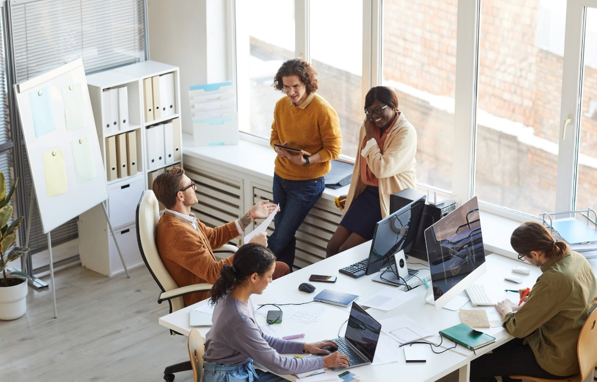 HBM interns and engineers collaborating around a workspace