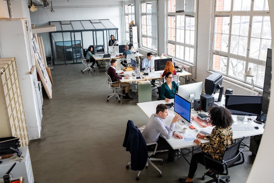 HBM engineers working at computer workstations in an open office.