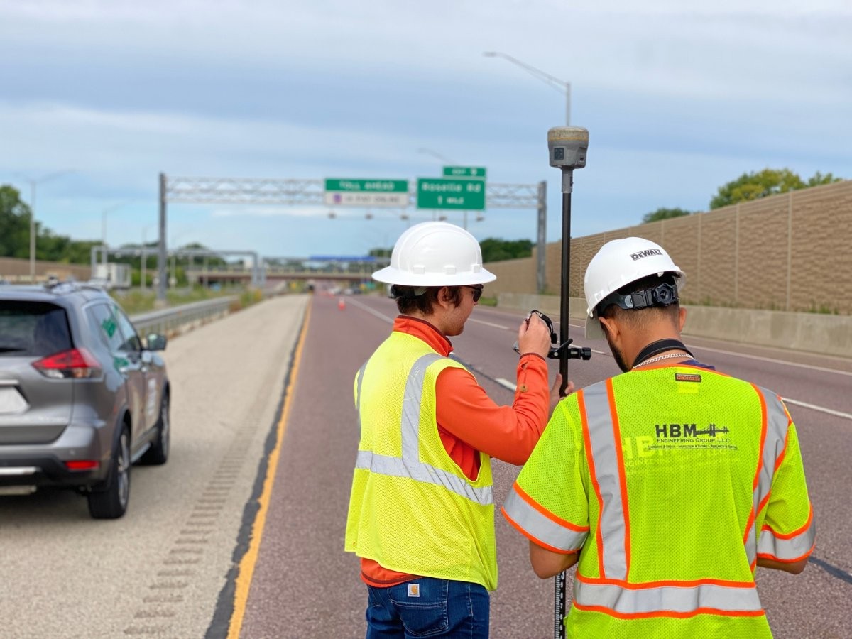 HBM survey crew in high-visibility vests working alongside a highway